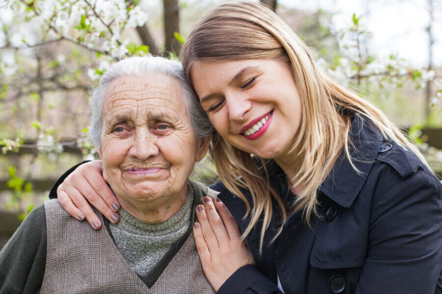 Woman embracing woman with dementia