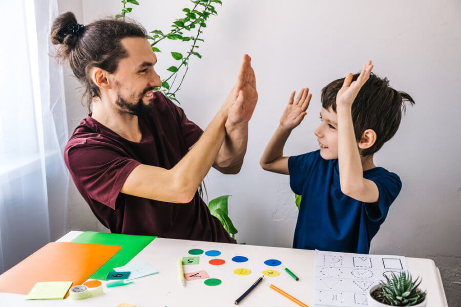 Child with autism spectrum disorder playing with an adult