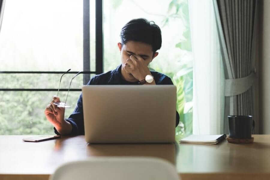 Young man struggling to cope with financial stress