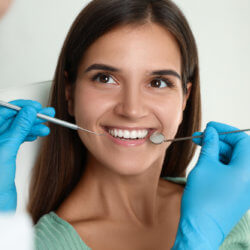 Woman getting a dental cleaning without insurance