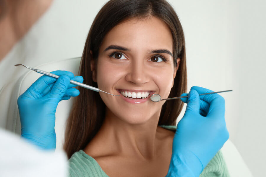 Woman getting a dental cleaning without insurance