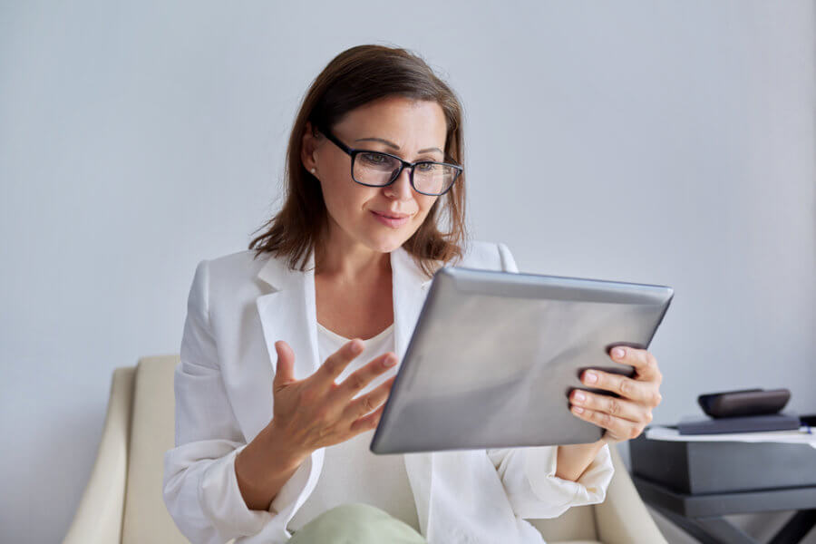 Woman trying to market her psychotherapy practice on her tablet