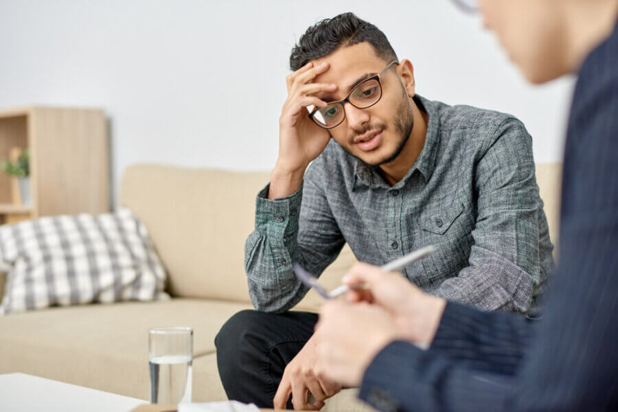 Man in therapy discussing male mental health stigma