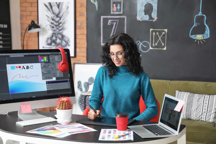 Woman works on a mental health logo design at desk
