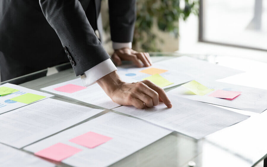 Business owner reviewing financial documents to plan for the sale of his business