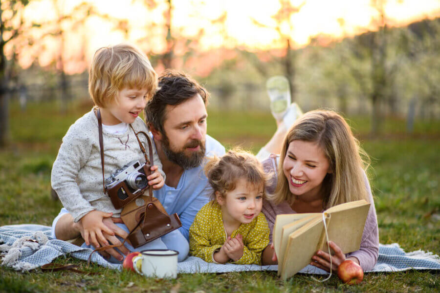 Father enjoying relief of neurological symptoms with Magnetic eResonance Therapy spending time outside with wife and children.