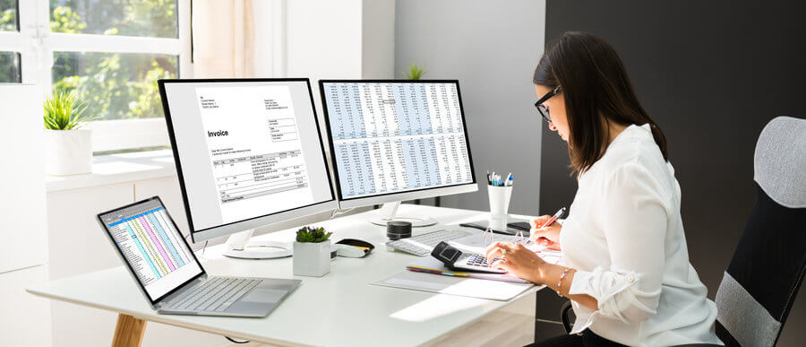 outsourced accountant running numbers on computer