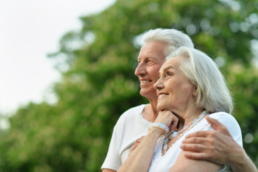 older couple happy and smiling outside