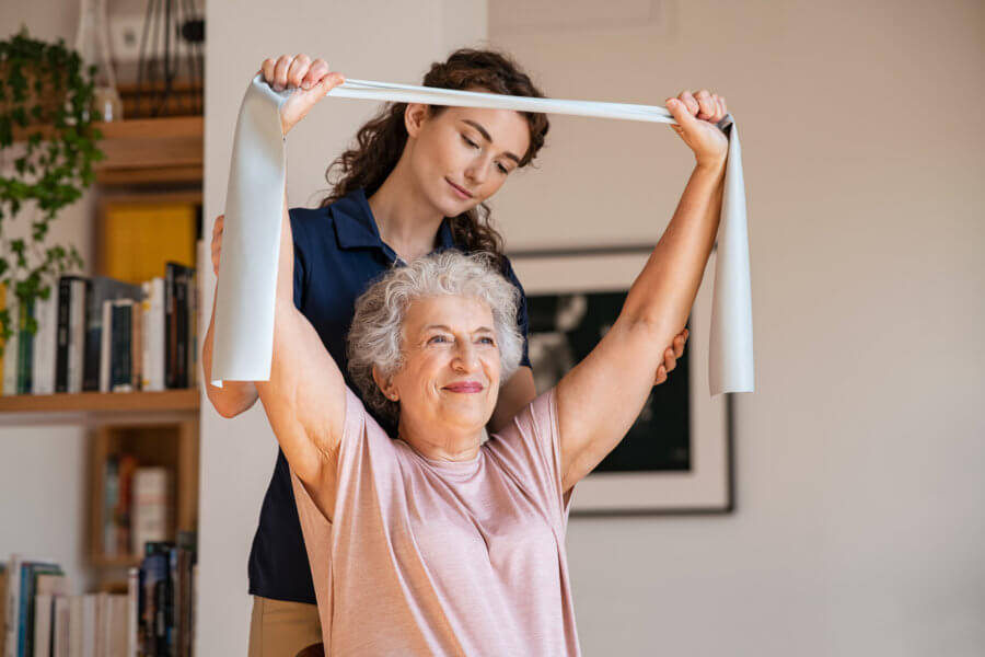 doctor helping woman with a mobility exercise