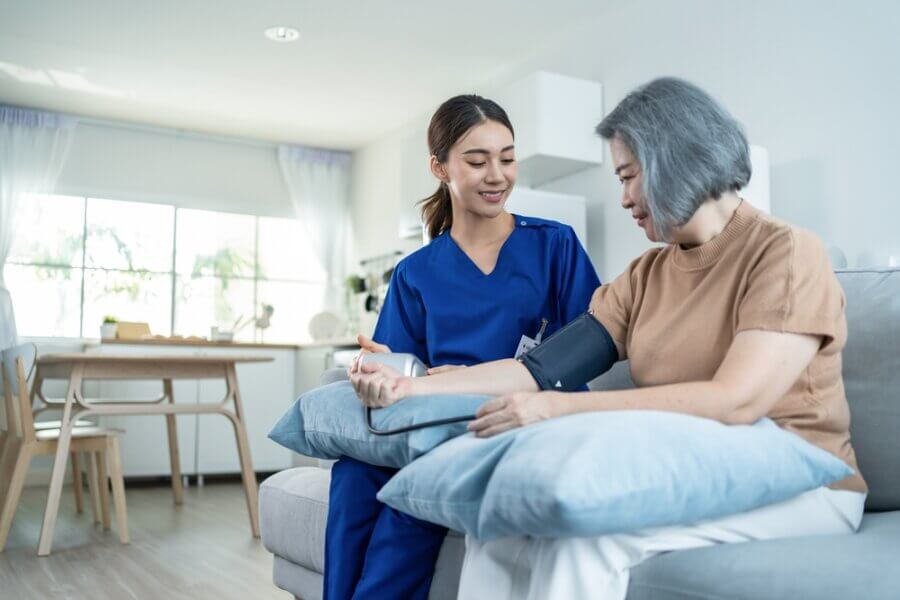 Registered nurse provides care for senior woman at home