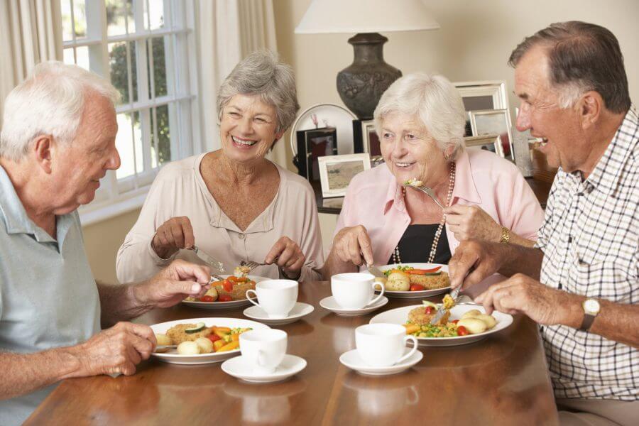 Alaskan seniors at Turnagain Social Club eat dinner together.