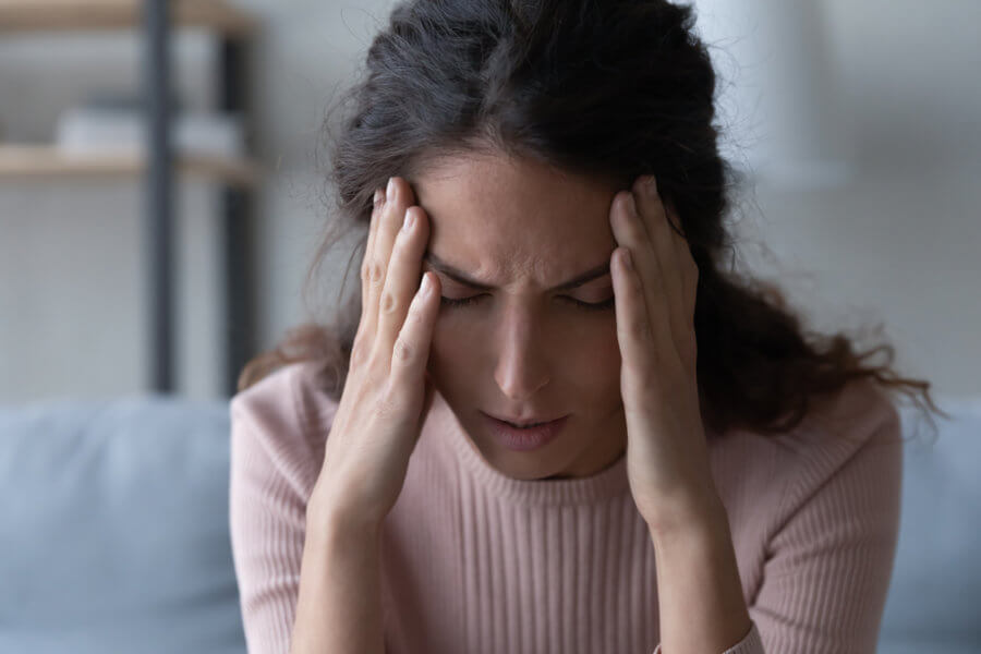 Woman in pain from an untreated tbi