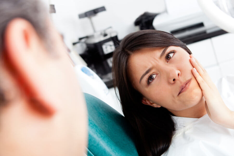 Woman getting checked for why her gums might be swollen