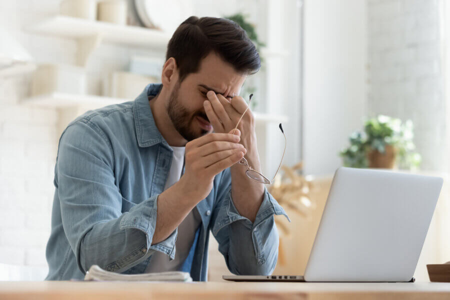 Man suffering from work from home burnout and zoom fatigue